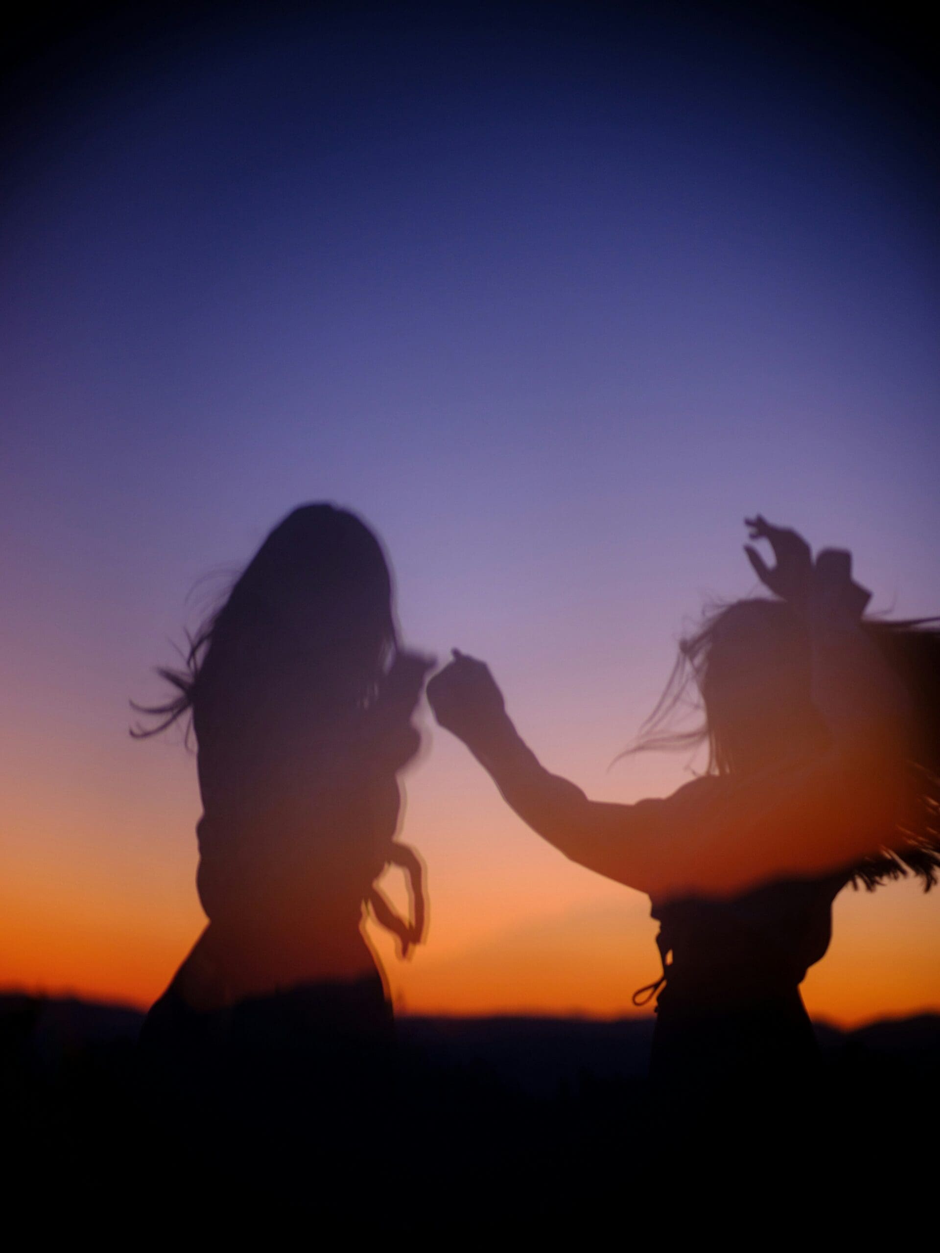 Silhouettes of two people moving together at sunset, symbolizing connection, embodiment, and emotional healing through somatic and trauma-focused therapy in Las Vegas, Nevada.