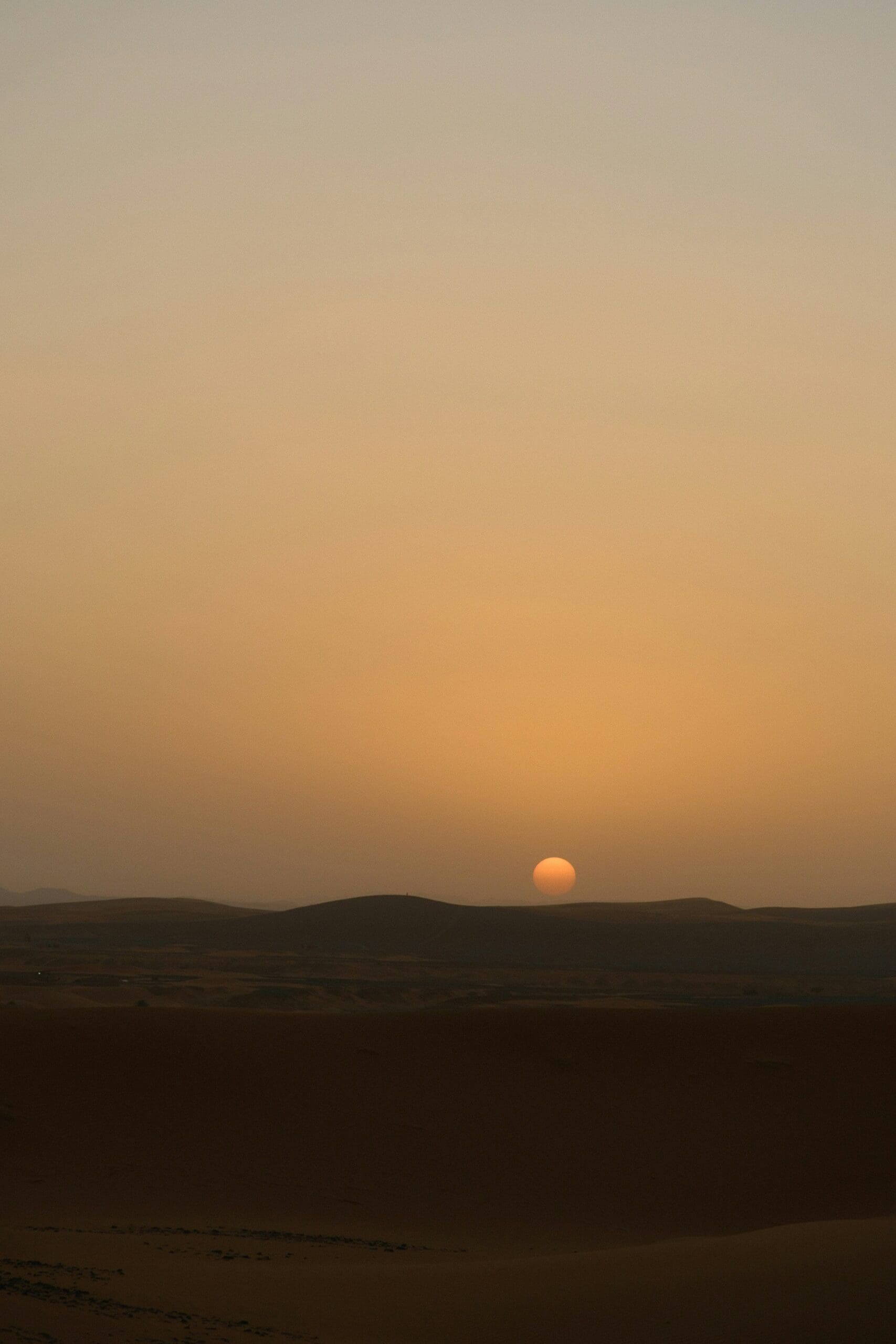 Desert sunset over soft sand dunes at dusk, symbolizing stillness, reflection, and renewal — representing Ominira Therapy’s trauma-focused somatic approach and mindful healing in Nevada.