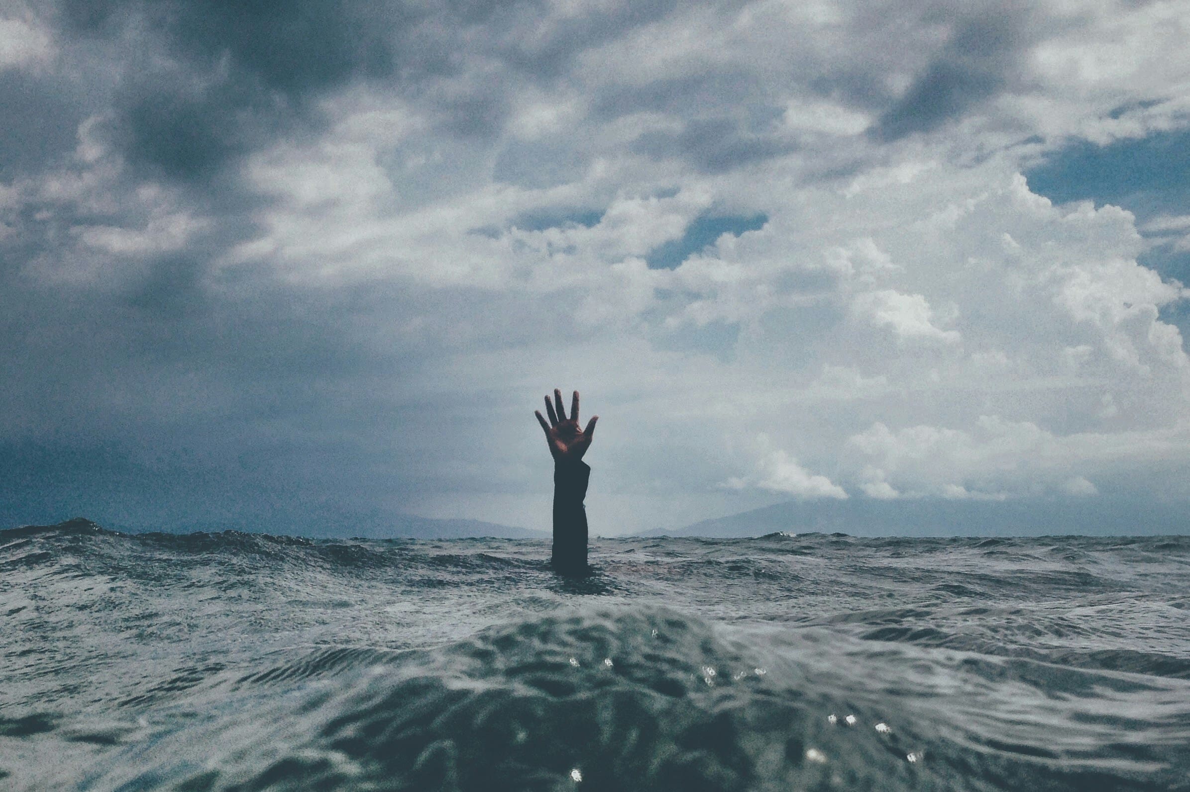 Exhausted professional sitting with head in hands, representing burnout, chronic stress, and trauma-related emotional overwhelm, Ominira Therapy Nevada